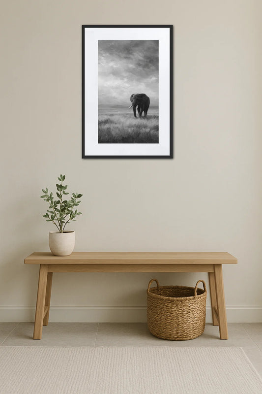 Tableau éléphant noir et blanc dans un paysage de savane avec ciel nuageux au-dessus d’un banc en bois et panier tressé