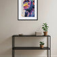 tableau singe pop art graffiti au dessus d’une console noire avec plantes