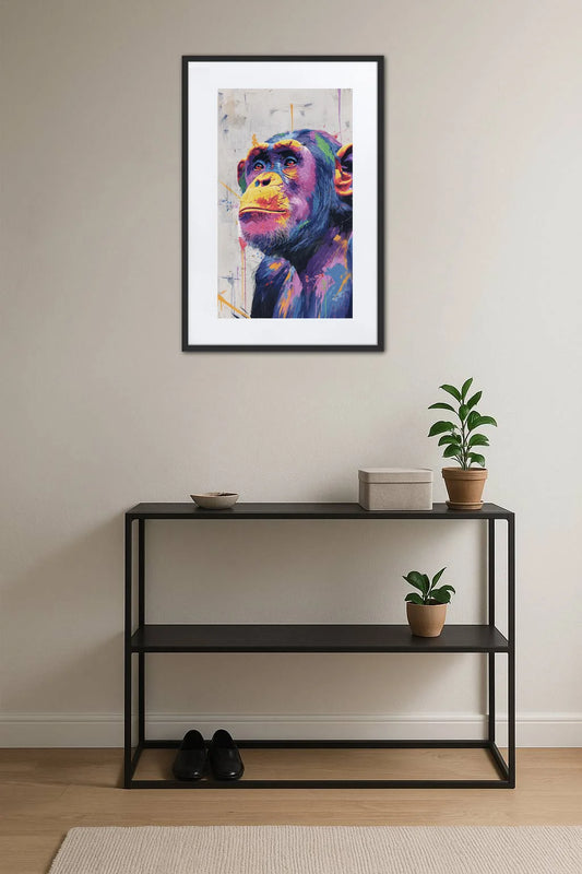 tableau singe pop art graffiti au dessus d’une console noire avec plantes